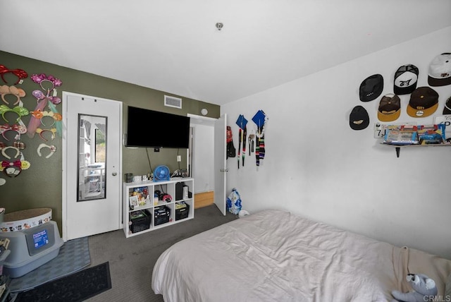 carpeted bedroom featuring visible vents