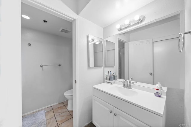 bathroom with visible vents, vanity, toilet, and tile patterned floors