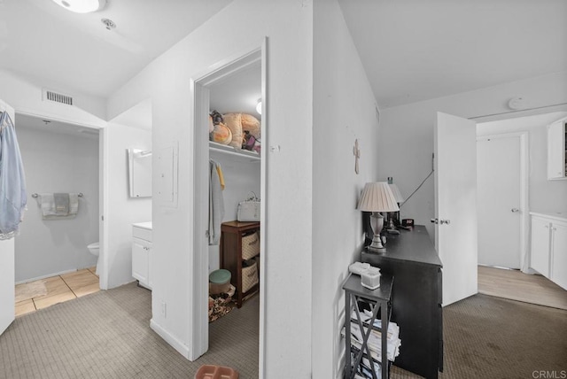 interior space with toilet, vanity, and visible vents