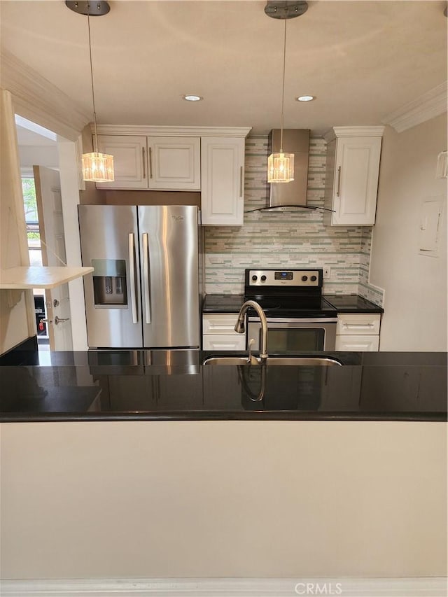 kitchen featuring appliances with stainless steel finishes, dark countertops, white cabinetry, and wall chimney exhaust hood