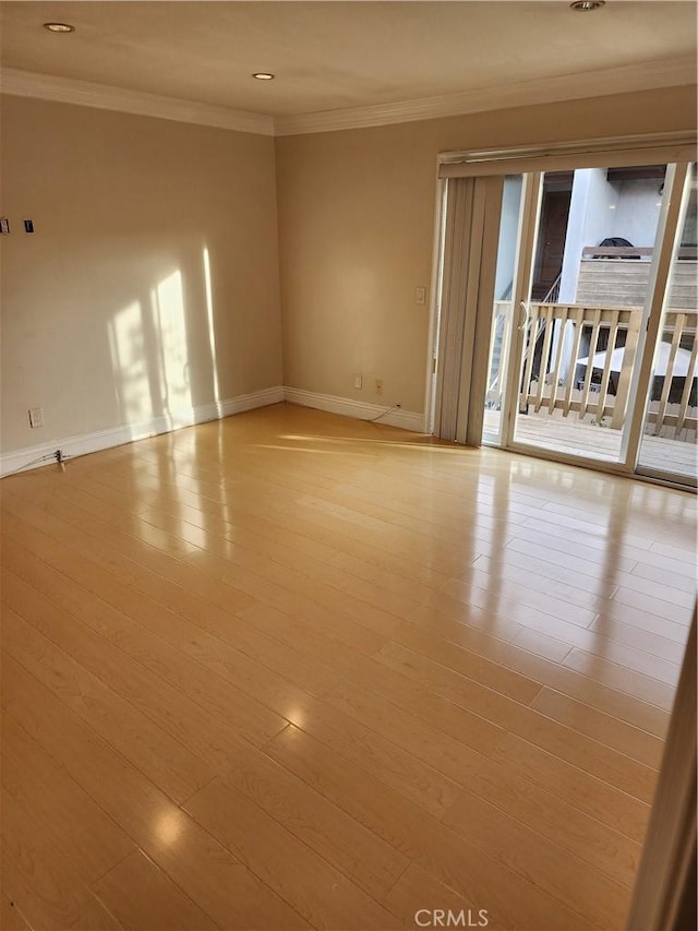 empty room featuring ornamental molding, recessed lighting, wood finished floors, and baseboards