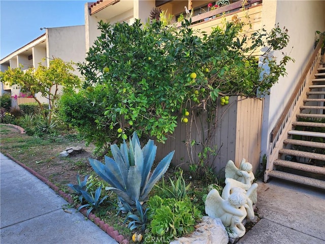 exterior space with stairs and stucco siding