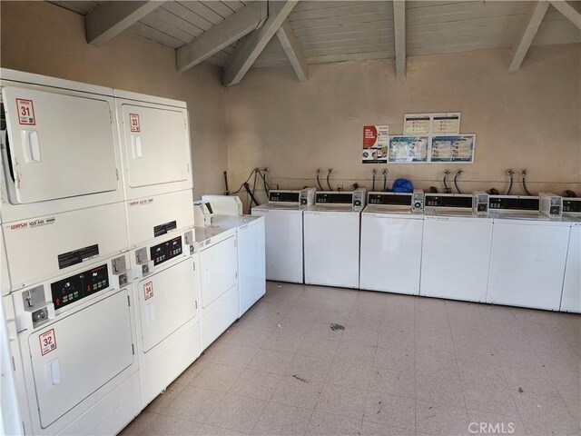 shared laundry area featuring light floors, separate washer and dryer, and stacked washer / drying machine