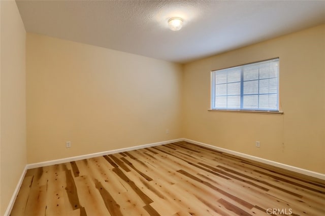 unfurnished room with hardwood / wood-style floors