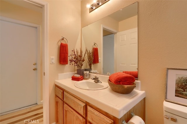 bathroom with vanity and toilet