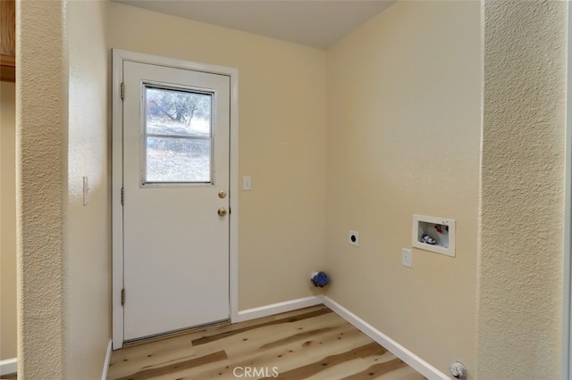 laundry area with hookup for a washing machine, light hardwood / wood-style flooring, and electric dryer hookup