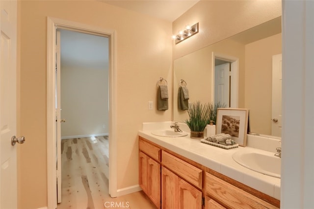 bathroom with wood-type flooring and vanity