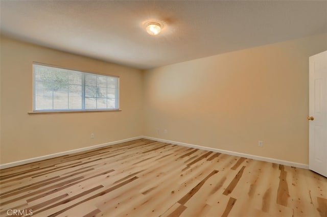 spare room featuring light hardwood / wood-style flooring