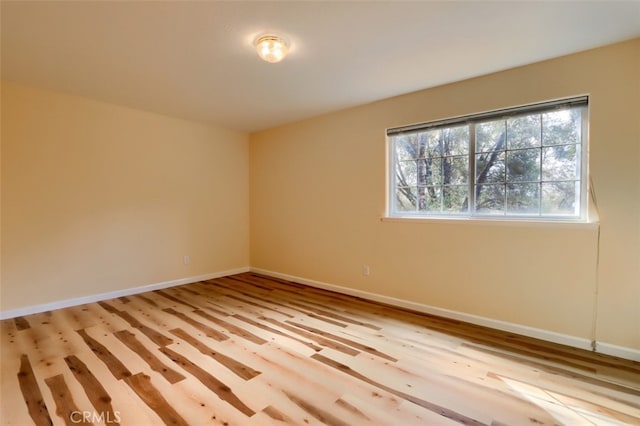 spare room with light hardwood / wood-style flooring