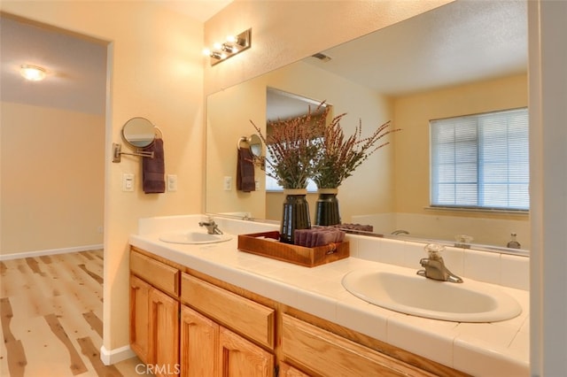 bathroom with vanity and wood-type flooring