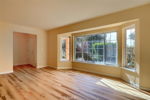 empty room with light hardwood / wood-style flooring