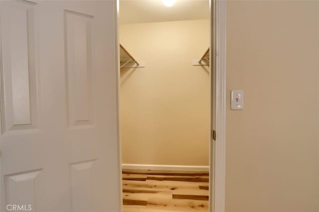 spacious closet with hardwood / wood-style floors