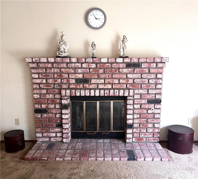 interior details featuring carpet flooring and a fireplace