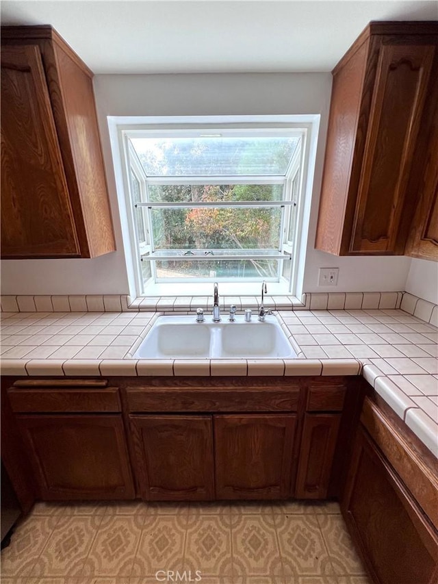 kitchen with tile countertops and sink