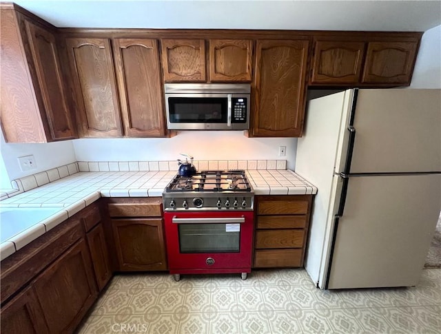 kitchen featuring tile countertops and stainless steel appliances