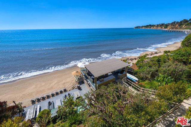 drone / aerial view featuring a water view and a beach view