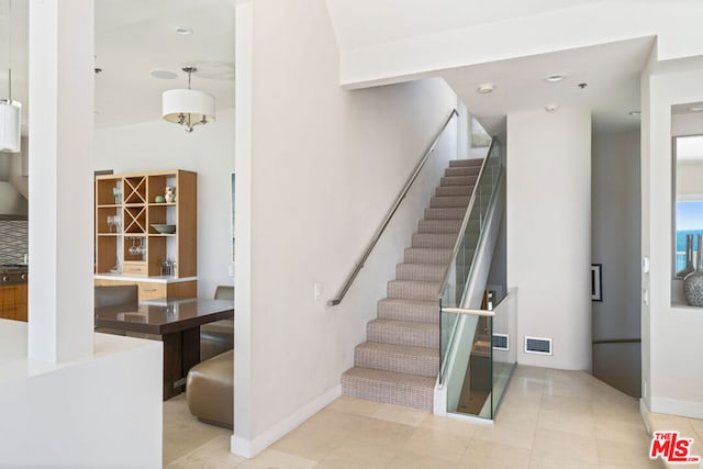 stairway with tile patterned flooring