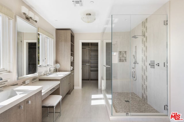 bathroom featuring vanity, tile patterned floors, and a shower with door