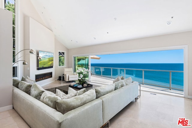 living room with vaulted ceiling, a water view, and light tile patterned flooring