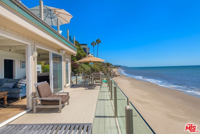 view of patio featuring a view of the beach and a water view