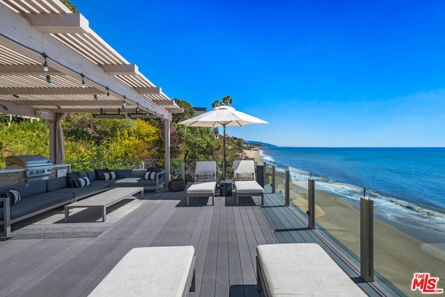 deck featuring a grill, a beach view, a pergola, an outdoor living space, and a water view