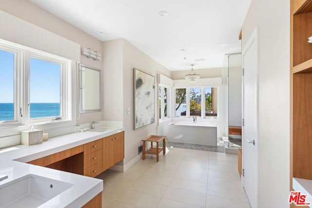 bathroom featuring tile patterned flooring, independent shower and bath, a notable chandelier, vanity, and a water view