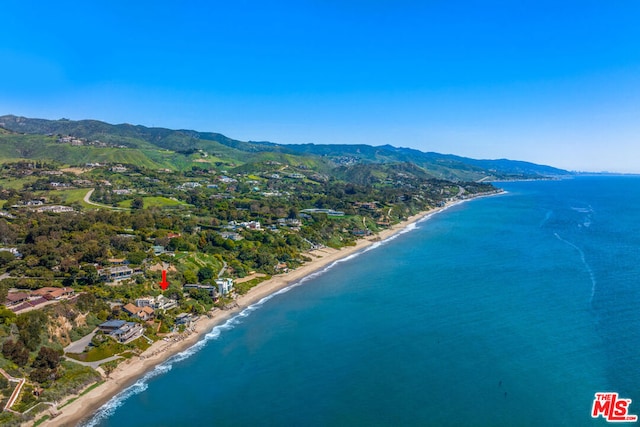 birds eye view of property with a water and mountain view and a view of the beach