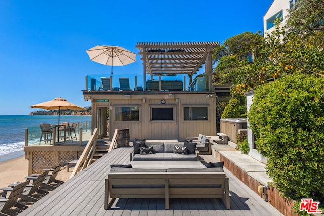 deck with an outdoor hangout area, a water view, a beach view, and a pergola