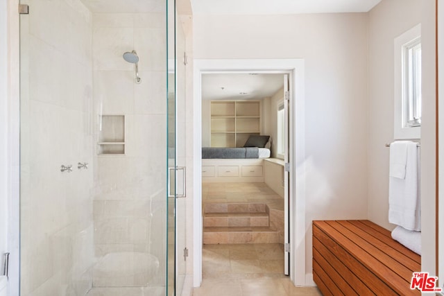 bathroom with a shower with door