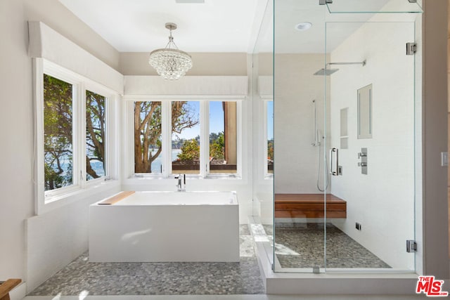 bathroom featuring walk in shower and an inviting chandelier