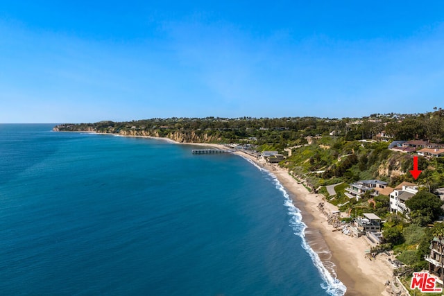 drone / aerial view featuring a water view and a beach view