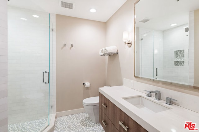 bathroom with toilet, an enclosed shower, vanity, and tile patterned floors