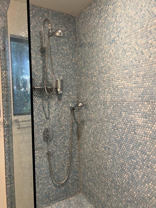 bathroom with tiled shower