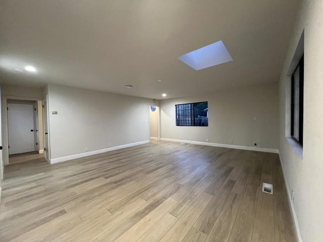 spare room with light hardwood / wood-style floors