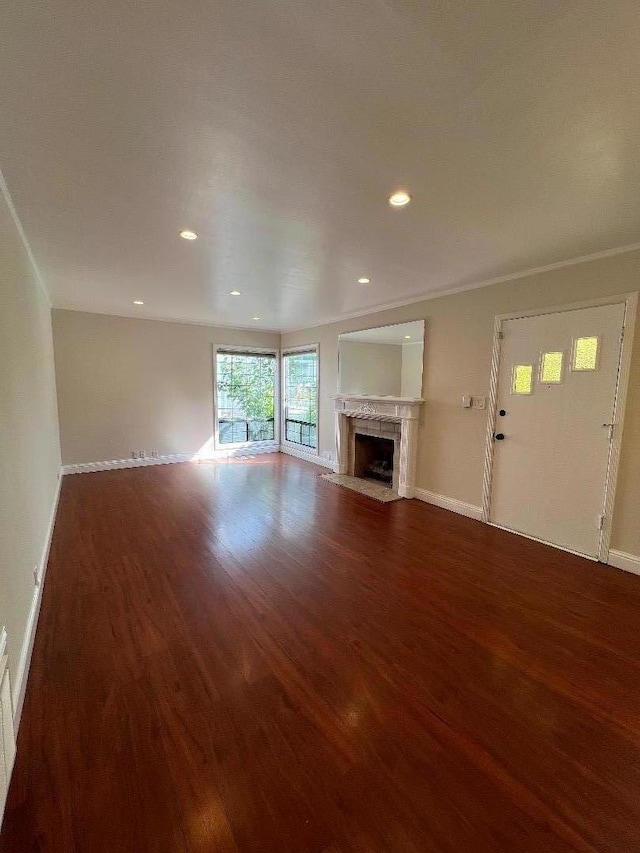 unfurnished living room with wood-type flooring and a high end fireplace