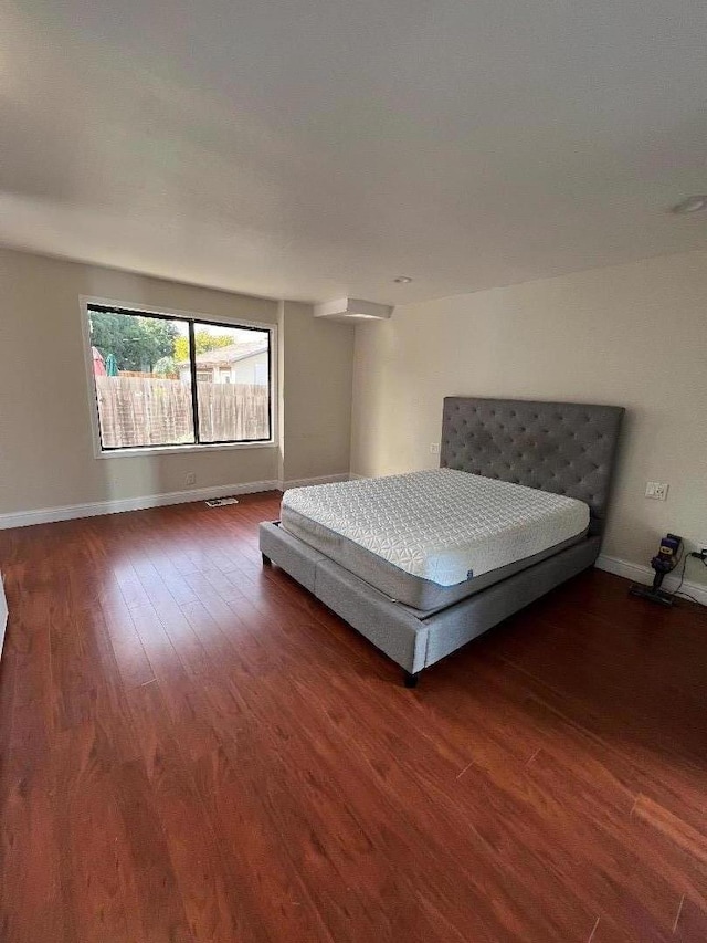 unfurnished bedroom featuring dark wood-type flooring