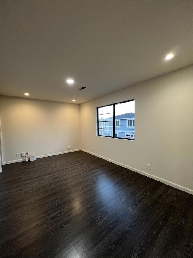 unfurnished room with dark hardwood / wood-style floors