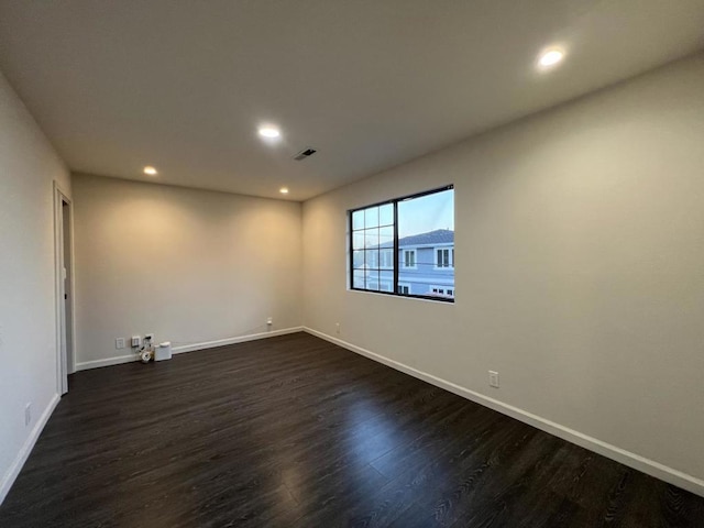 empty room featuring dark wood-type flooring