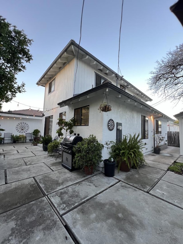 back of property with a patio