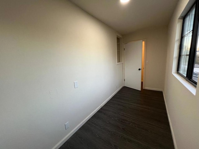 corridor featuring dark wood-type flooring