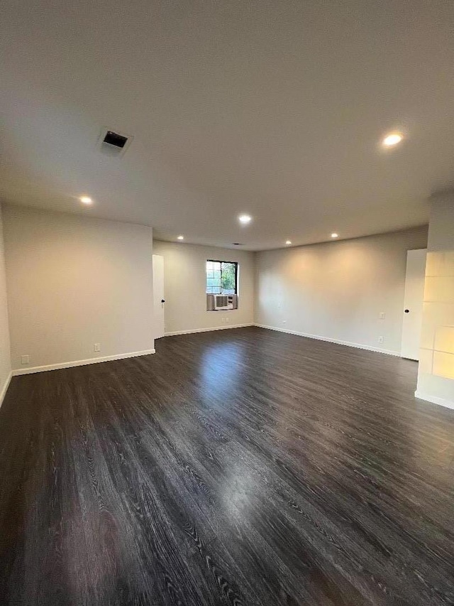 spare room featuring dark wood-type flooring and cooling unit