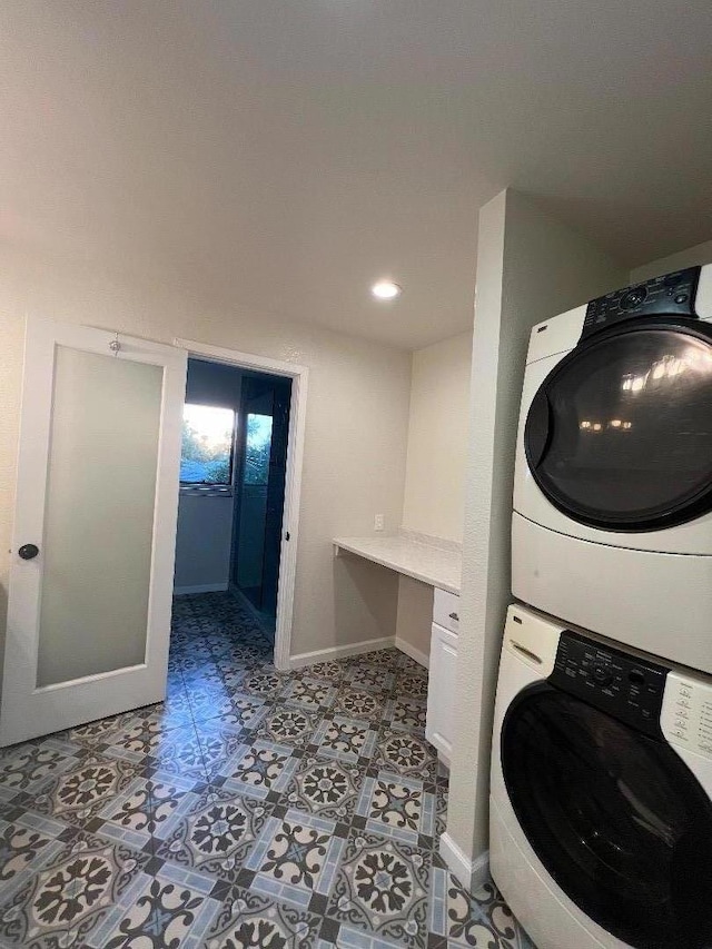 laundry area featuring stacked washing maching and dryer