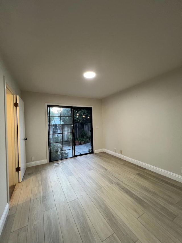 spare room with light hardwood / wood-style flooring