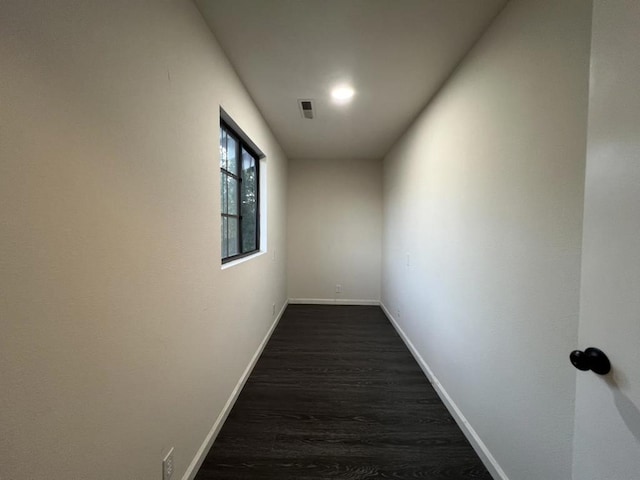 hallway with dark hardwood / wood-style flooring