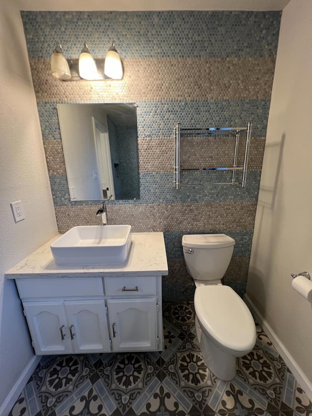 bathroom featuring vanity, toilet, and tile patterned flooring