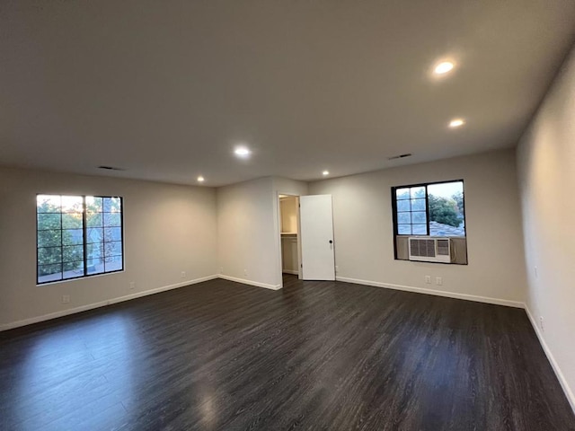 unfurnished room with cooling unit and dark hardwood / wood-style flooring