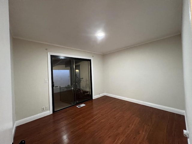 unfurnished room with hardwood / wood-style flooring and crown molding