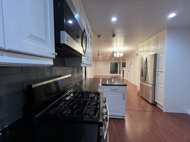 kitchen featuring decorative light fixtures, dark wood-type flooring, white cabinetry, a notable chandelier, and stainless steel appliances