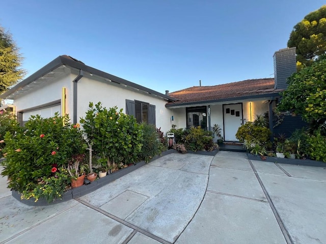 ranch-style house featuring a garage and covered porch