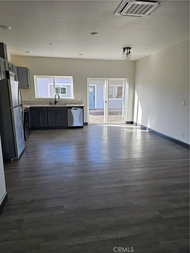 interior space featuring appliances with stainless steel finishes, dark hardwood / wood-style floors, sink, and gray cabinets